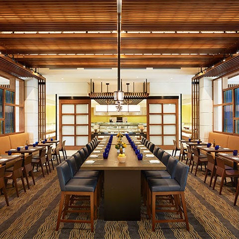 Interior of dining room showing the large center table without guests.