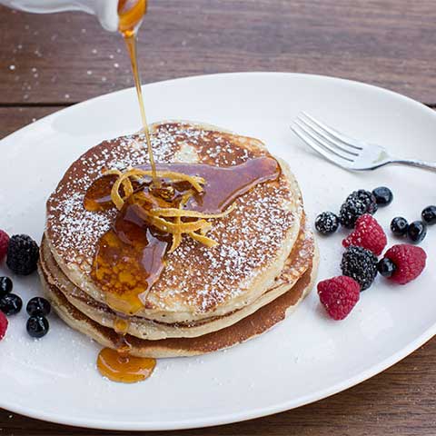 Pancakes served with syrup.