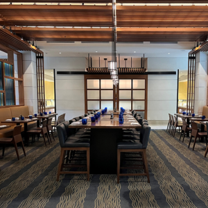 200s Large dining room at Plateia with tables, chairs, and place settings.